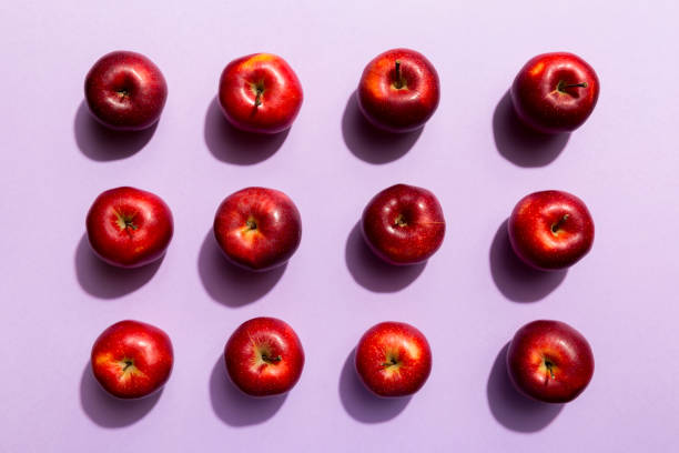 istock Many red apples on colored background, top view. Autumn pattern with fresh apple above view 1395865482