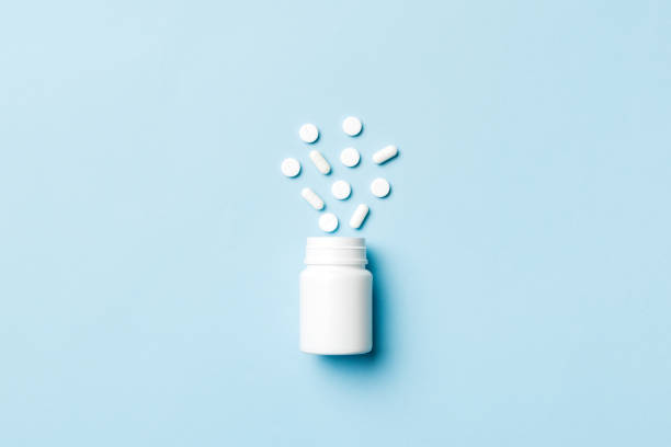 istock Multicolored pills and capsules in plastic bottle on Colored background, copy space. Many different various medicine tablets and pills, vitamin and nutritional supplements concept 1395865603