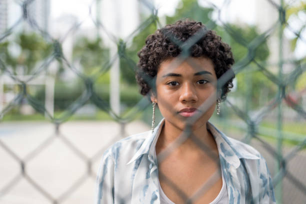 istock young latin woman looking at the camera with serious face. 1395868771