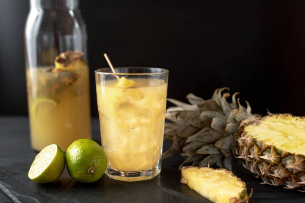 istock Fruit and pineapple drink with ice on a black background 1395869572
