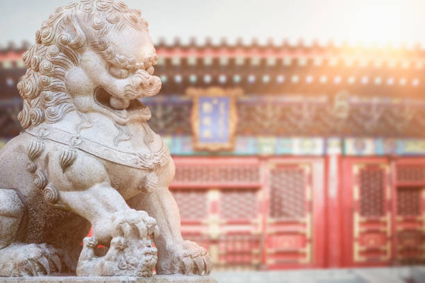 Chinese Temple Foo Dog Lion guard statue with Chinese traditional temple exterior Chinese Temple Foo Dog Lion guard statue with Chinese traditional temple exterior, retouched digital composite image chinese temple dog stock pictures, royalty-free photos & images