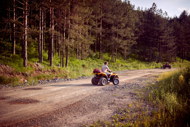 istock Group of enthusiastic friends driving quads 1395873448