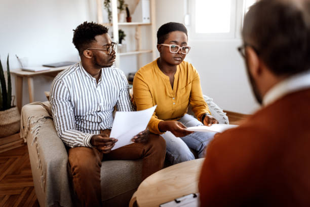 istock Marriage counselor giving documents to couple in office 1395875318