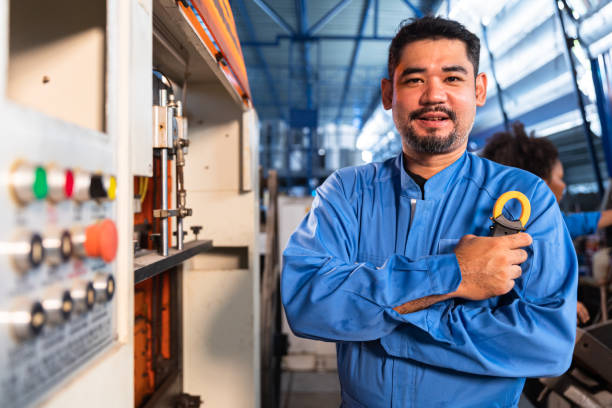 istock Senior asian engineer man worker  in protective uniform operating machine at factory Industrial.Teamwork working in industry. 1395875476