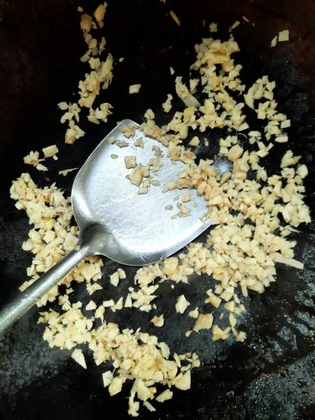 istock Chopped Ginger on cooking pan - food preparation. 1395875514
