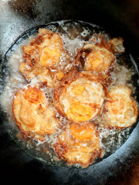 istock Cooking Fried Eggs in Chopped Ginger Brown Soup - food preparation. 1395876226