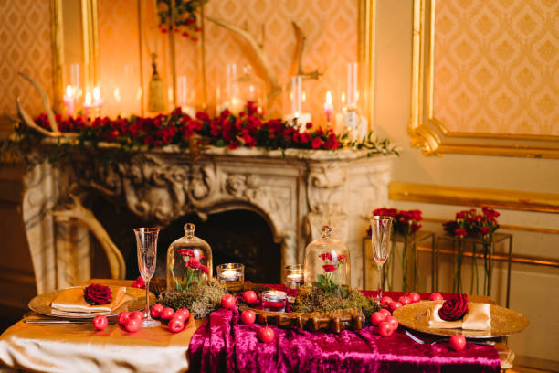 istock Table setting at a wedding reception in the evening. Floral compositions and candles on the decorated dining table. 1395877258