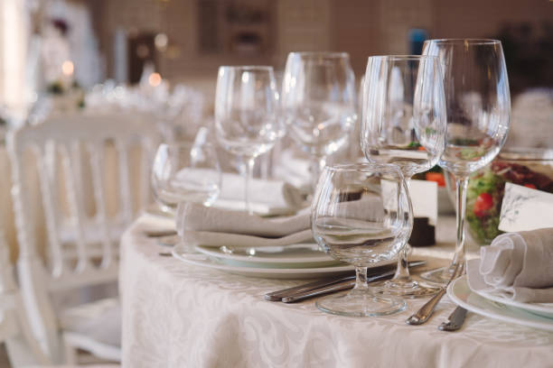 istock Table setting at reception or event, glassware and cutlery on the dinner table 1395877518