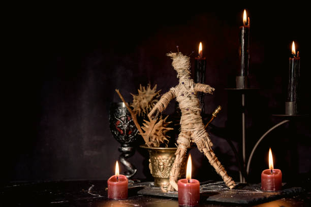 istock Voodoo doll, black candles, pentagram and old books on witch table. Occult, esoteric, divination and wicca concept. Mystic, voodoo and vintage background. 1395877907