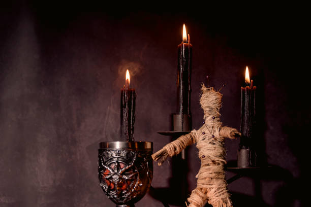 istock Voodoo Doll on a wooden background with dramatic lighting. 1395878425