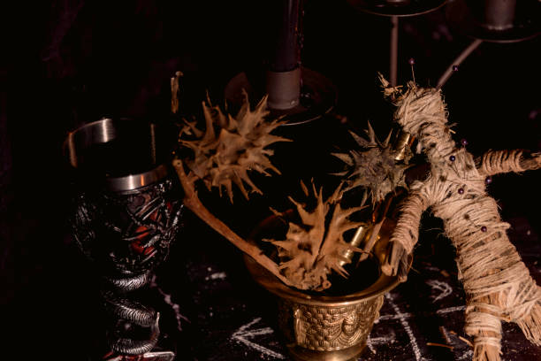 istock Voodoo doll, black candles, pentagram and old books on witch table. Occult, esoteric, divination and wicca concept. Mystic, voodoo and vintage background. 1395878437