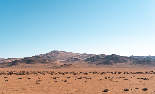 Panoramic horizontal shot of mountains and dunes of the Atacama Desert, Caldera, Chile.