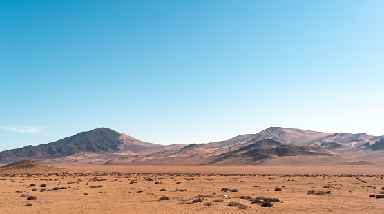 Horizontal shot of mountains and dunes of the Atacama Desert, Caldera, Chile.