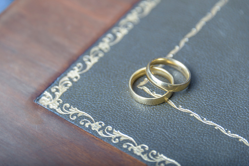 Golden wedding rings with judge gavel, closeup