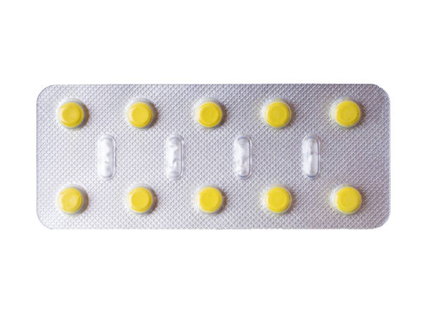 istock Yellow pills in a grey blister pack. Close-up 1395886246