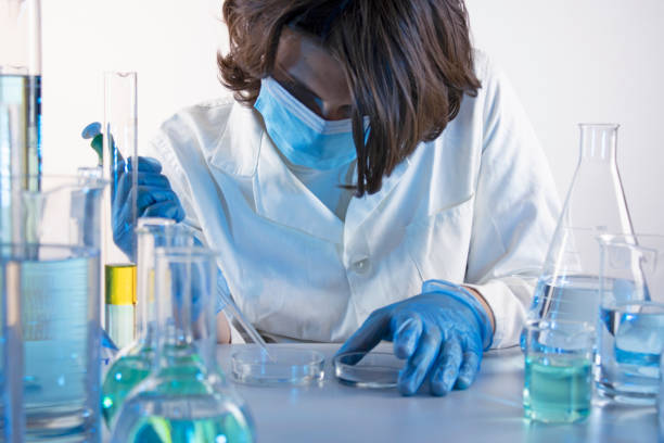 istock Young scientist taking samples with a pipette, in a laboratory 1395889375