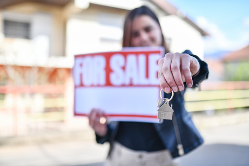 Cute Female With Long Hair Putting House For Sale