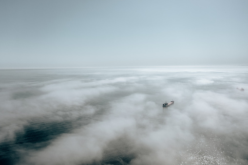 Clouds over sea. Foggy weather over sea. Top view of sea. Aerial view. Sea mist