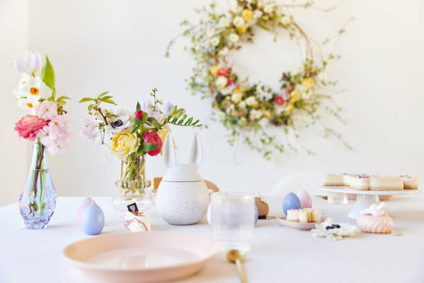 istock A modern table decoration as an Easter table with a floral Easter wreath hanging on the wall 1395890563