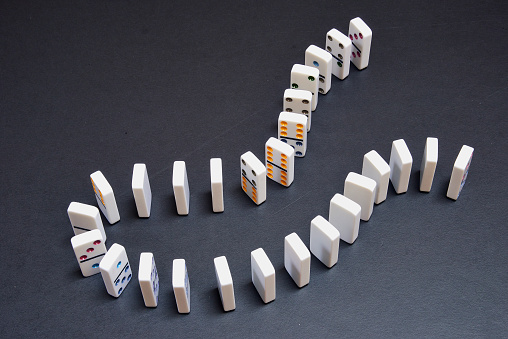 Lot of pieces of dominoes on black table