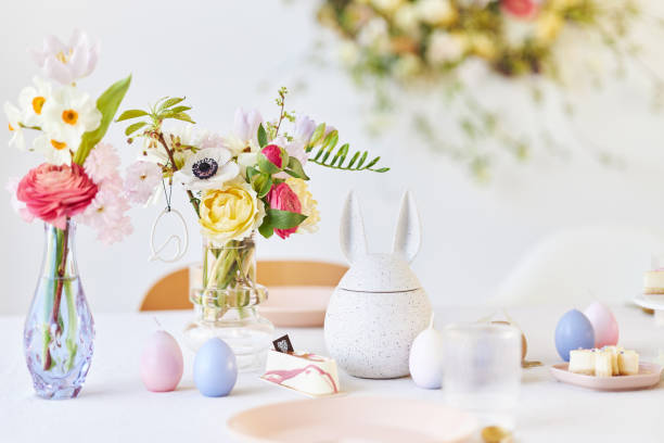 istock A modern table decoration as an Easter table with a floral Easter wreath hanging on the wall 1395890627