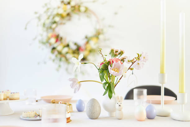 istock A modern table decoration as an Easter table with a floral Easter wreath hanging on the wall 1395890696