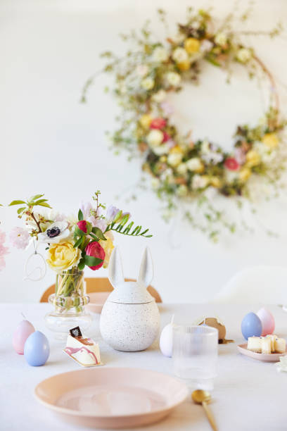 istock A modern table decoration as an Easter table with a floral Easter wreath hanging on the wall 1395891340