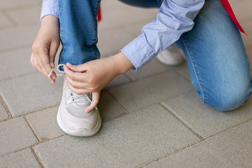 Child tying shoelace