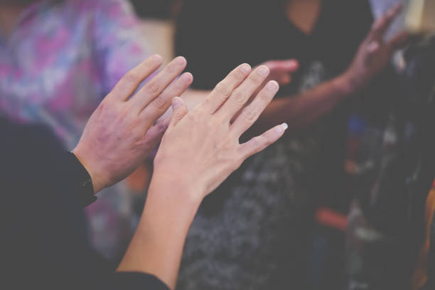 istock People praying together at church. 1395896447