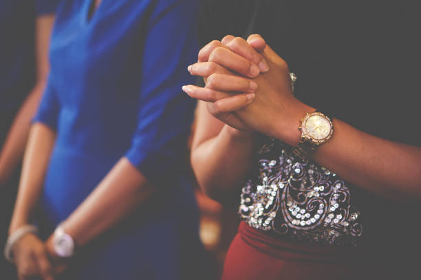 istock People praying together at church. 1395896471