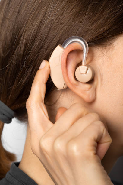 istock Hearing aid on a woman's ear. Deafness. 1395899233