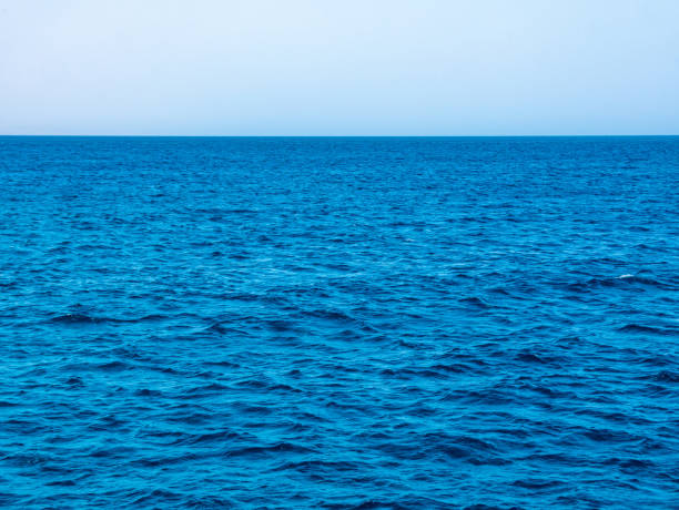 istock Waves on blue sea surface, horizon and blue sky. 1395900049