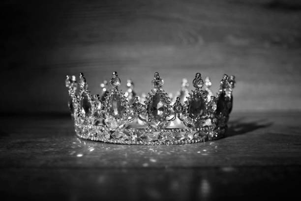 istock Royal golden crown with ruby, garnet gemstones, qrystals. Black and white 1395900145