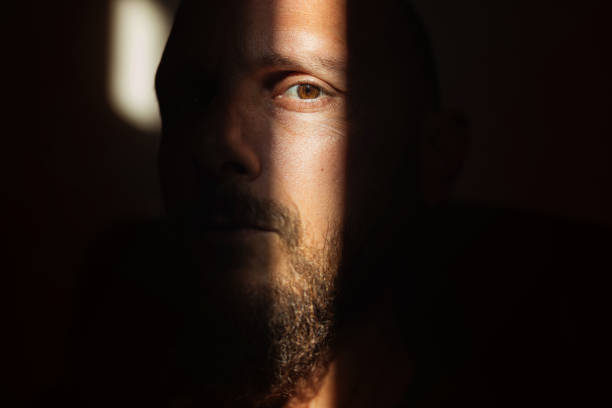 istock Dramatic light portrait: bearded man in the shadow 1395904010