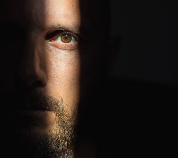 istock Dramatic light portrait: bearded man in the shadow 1395904028