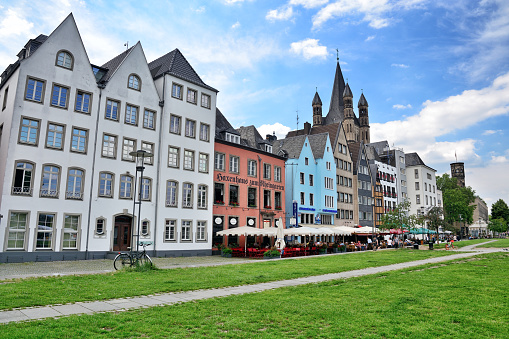 Colorful houses with the Great St. Martin Church in the background in Cologne, Germany
