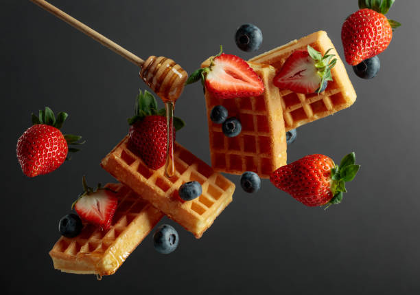 istock Waffles with blueberries, strawberries, and honey. 1395907944