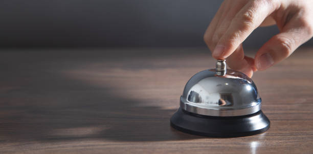 istock Male hand ringing in service bell. 1395908842