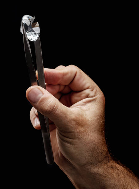 istock Large gemstone in jeweler's hand close up. Gem identifying and evaluating process. 1395908912