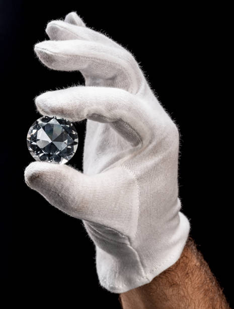 istock Large gemstone in jeweler's hand close up. Gem identifying and evaluating process. 1395908997