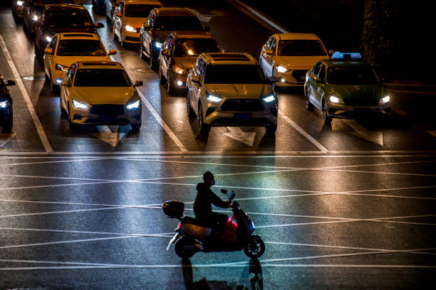 istock A shadow of scooter driving through the road intersection 1395910275