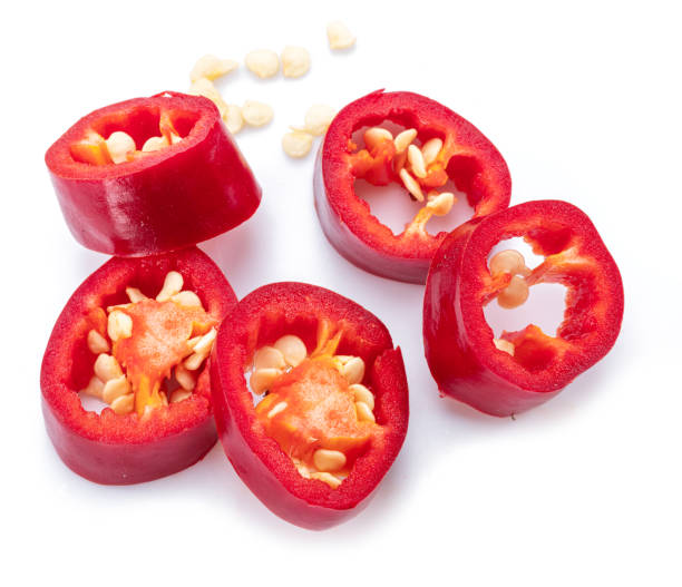 istock Cross sections of fresh chilli pepper with seeds isolated on white background. 1395912052
