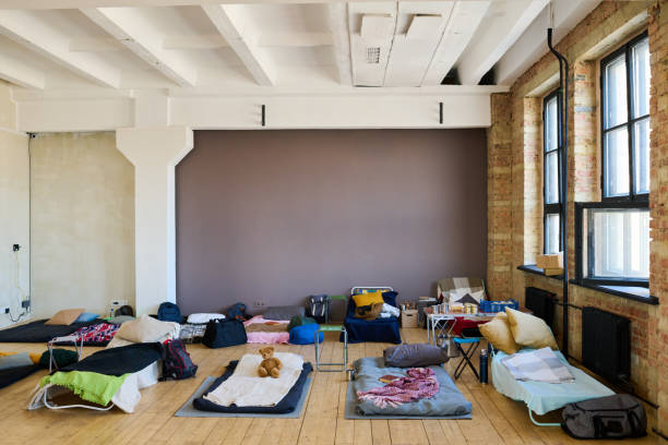 istock Spacious room with rows of beds prepared for migrants or refugees 1395914324