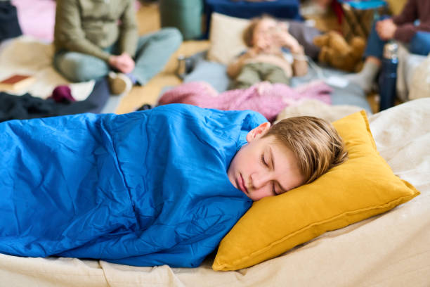 istock Peaceful schoolboy napping on sleeping place under blue blanket 1395914418