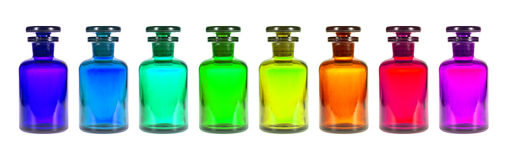 Small colorful Pharmacy bottles against a white background.