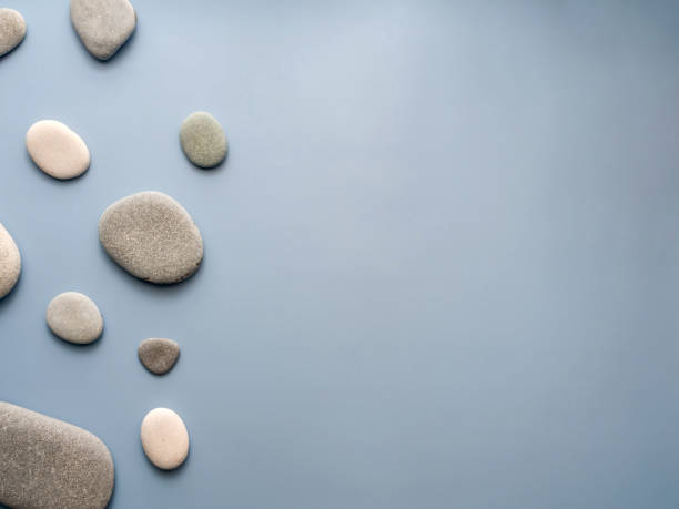 istock Flat spa stones (pebbles) on a blue background. View from above. Flat lay. Horizontally. Place for text. copy space 1395918783