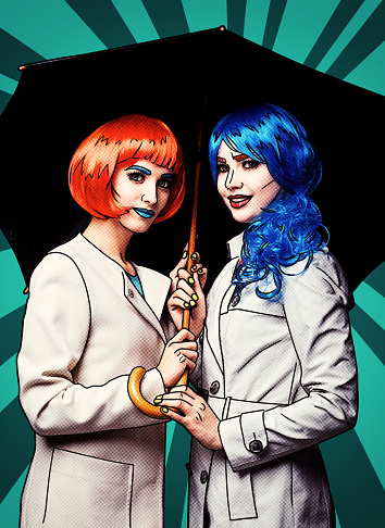 Portrait of young women in comic pop art make-up style. Females with umbrella on green cartoon background.
