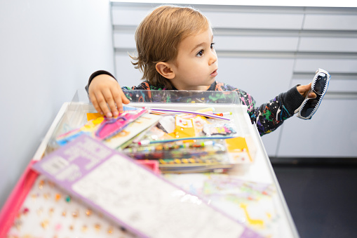 Boy with coloring pages, stickers and books