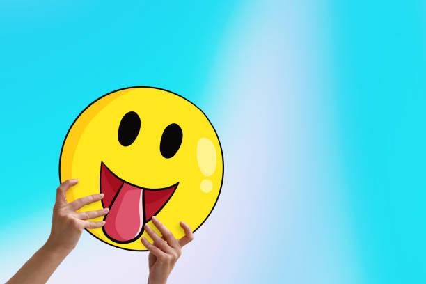istock Woman holding emoji 1395924303