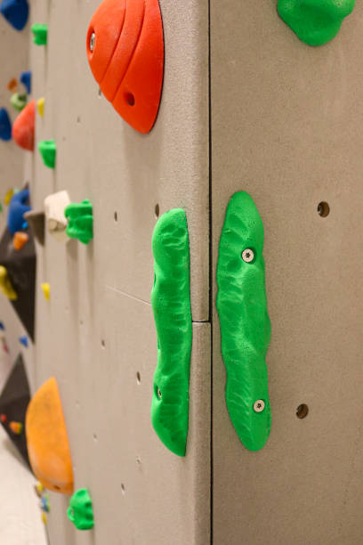 istock Climbing holds in different colors on indoor climbing wall 1395929855